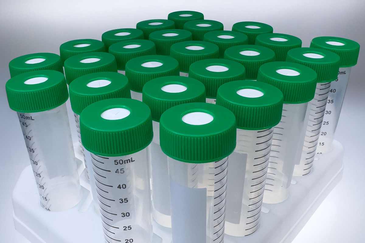 50 mL cross-cut septa caps with centrifuge tubes Clear 50 mL centrifuge tubes with green cross-cut septa caps, arranged upright in a white rack.